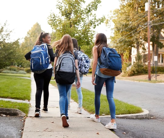 A group of preteen girls walking to school together