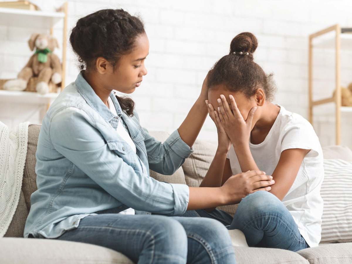 mother consoling crying daughter