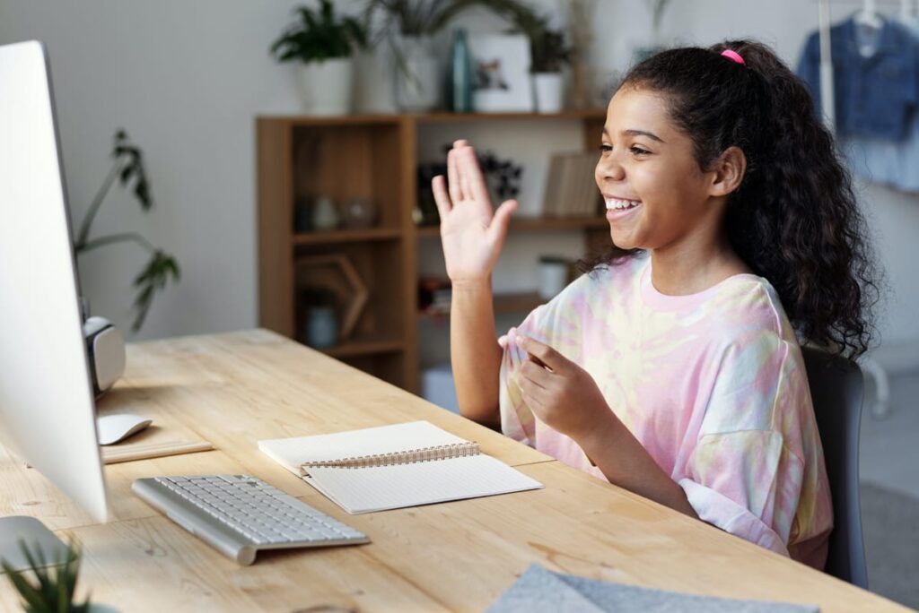 Young girl Waving At Computer